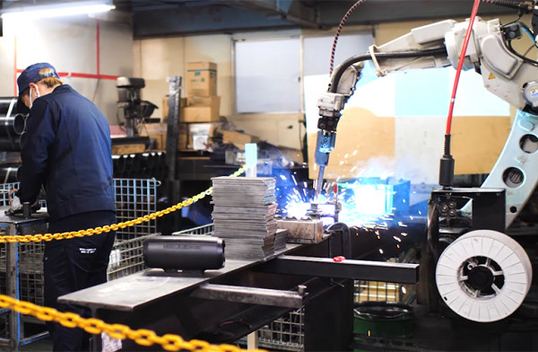 Photo: Employees and a welding robot