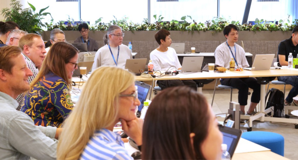 People of different nationalities discussing in a conference room
