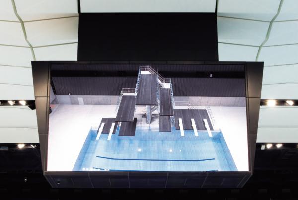 写真：メインアリーナ中央の大型映像表示装置にプールの様子を映している。