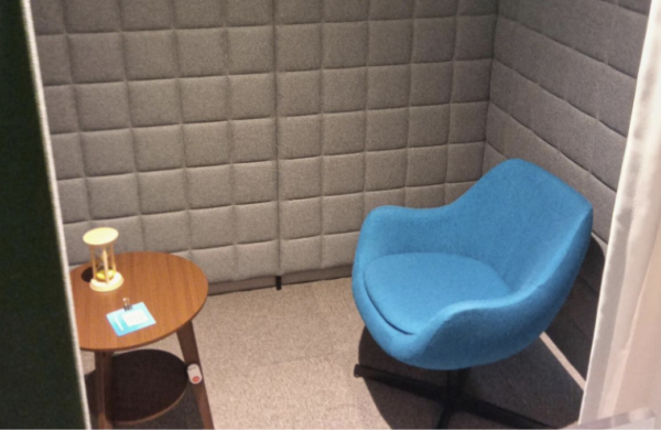 A private room with a single sofa and a small table